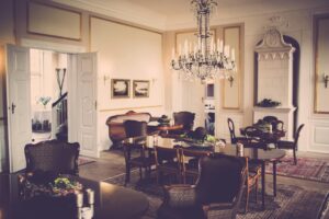 A vintage-style dining room showcasing a grand chandelier and classic furniture design.