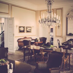 A vintage-style dining room showcasing a grand chandelier and classic furniture design.